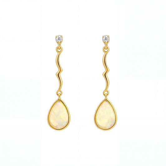 Gold earrings with teardrop-shaped stones on a white background