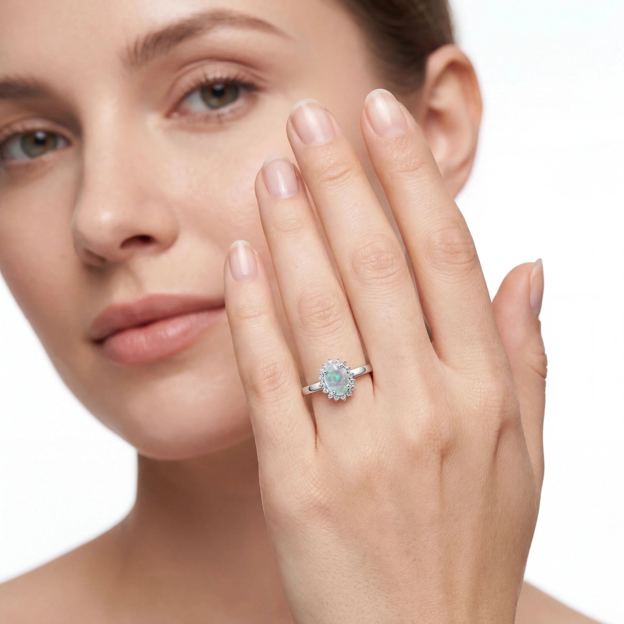 Woman wearing a diamond ring on her finger with a close-up of the ring.