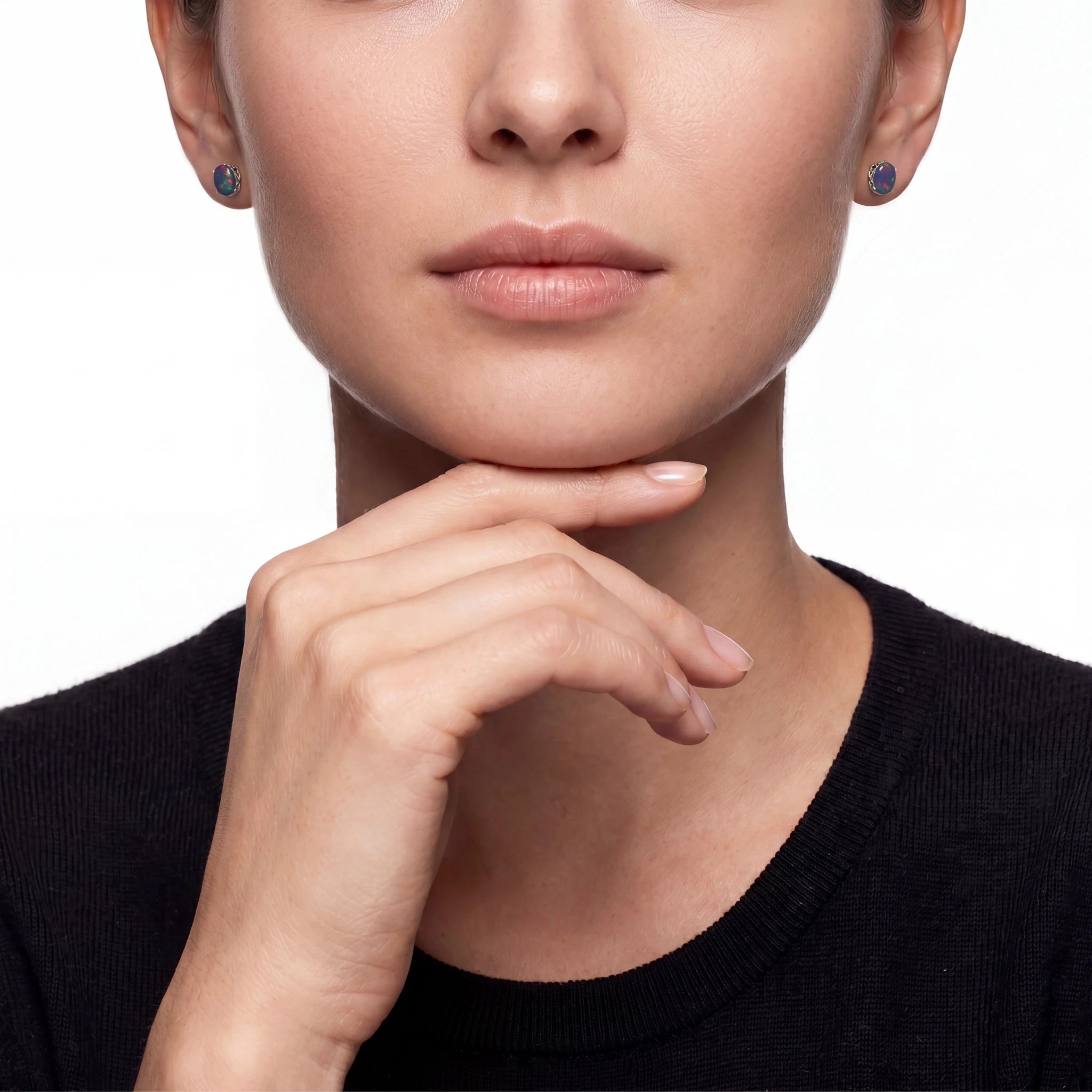 Close-up of a woman's face wearing earrings with a neutral background
