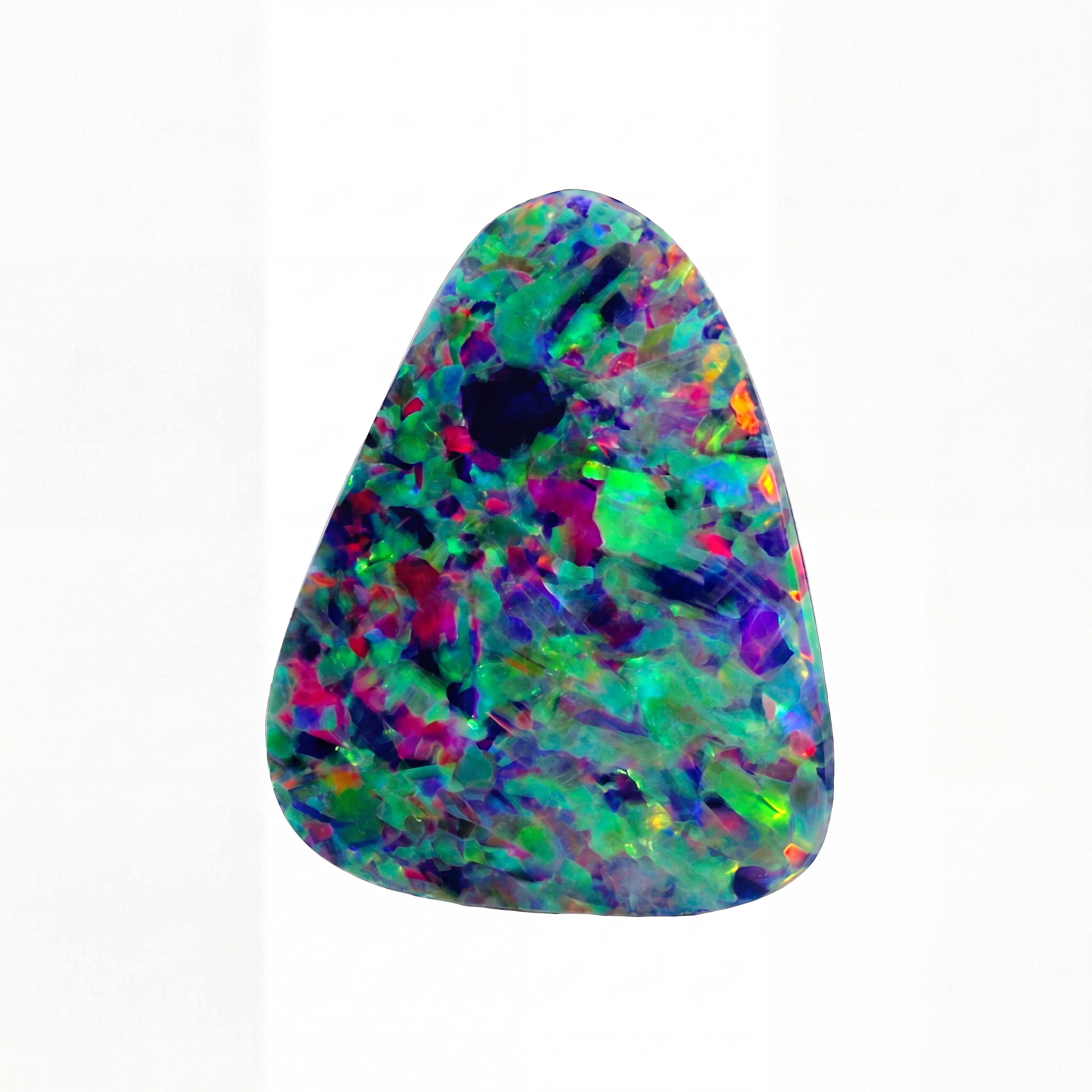 A triangular opal gemstone displaying a vibrant multicolour play-of-colour with flashes of green, blue, purple, red, and yellow on a solid black background.