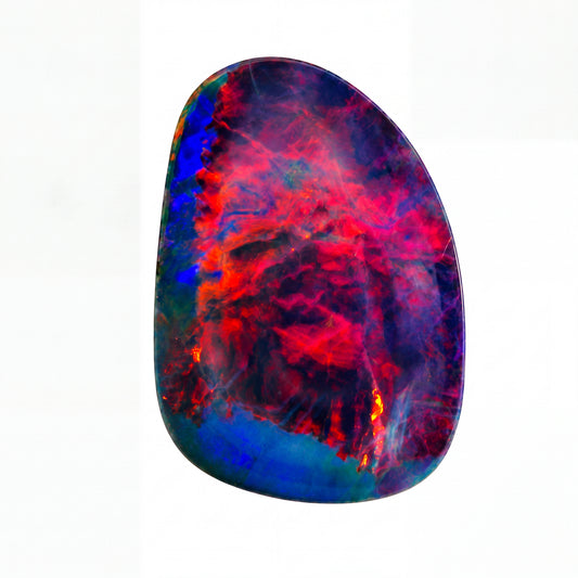 A polished irregular-shaped opal gemstone featuring a vibrant marbled pattern of red, blue, purple, and orange, set against a plain white background.