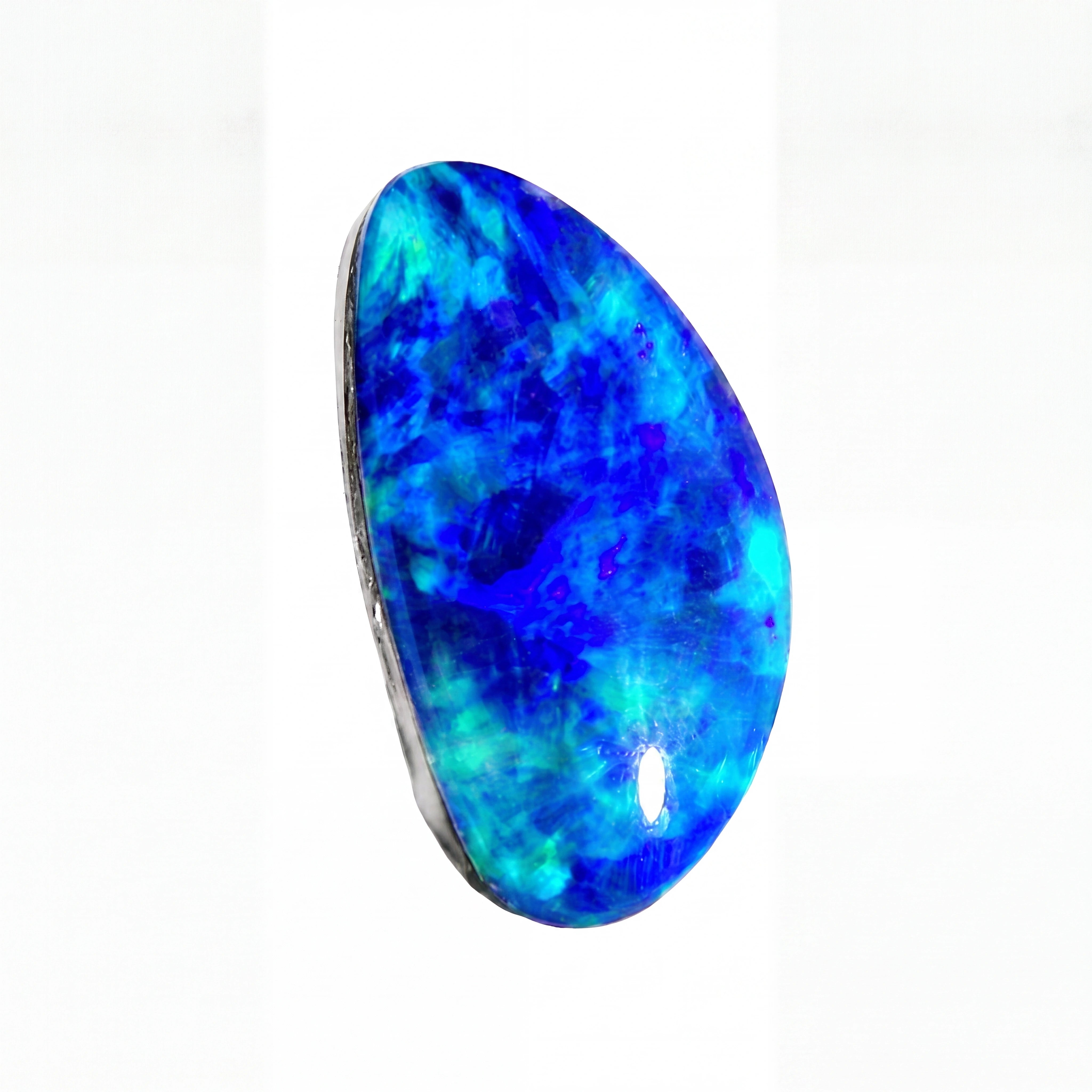A polished teardrop-shaped blue opal gemstone with vibrant blue, cyan, and purple marbling, set in a dark bezel on a plain white background.