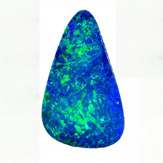 A teardrop-shaped blue opal gemstone with vibrant green flashes, displayed against a solid white background.