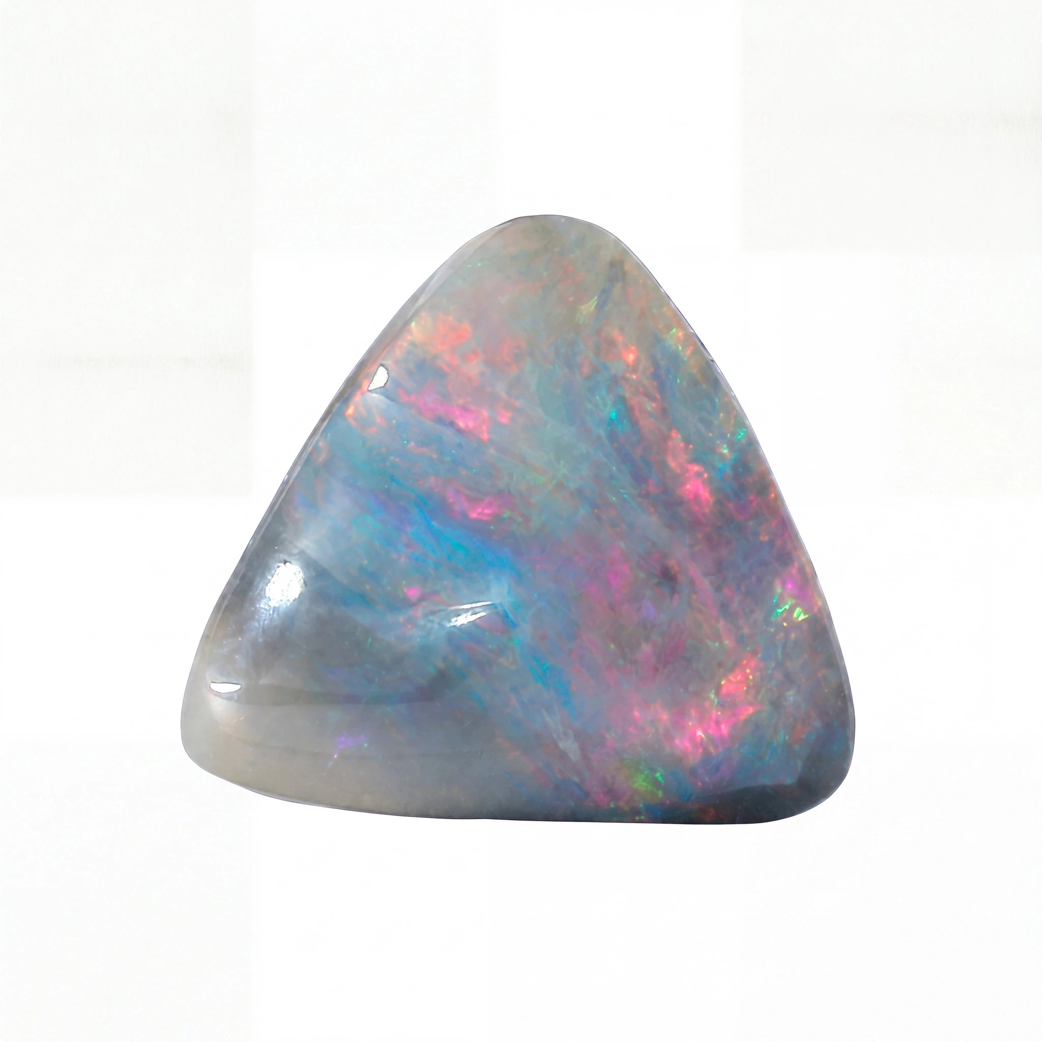 A polished triangular opal stone with a grey base and vibrant iridescent flashes of pink, blue, green, and orange, set against a plain white background.
