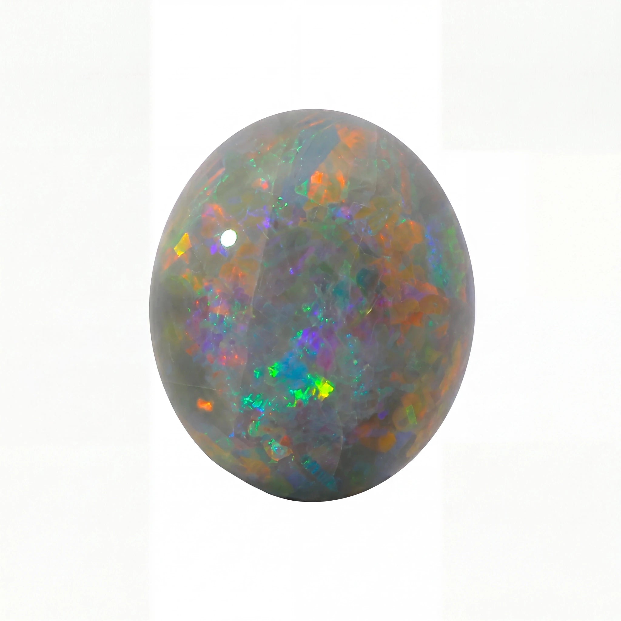 A polished oval cabochon opal gemstone displaying a play-of-colour with iridescent flashes of green, orange, blue, and purple on a dark grey base, set against a plain white background.