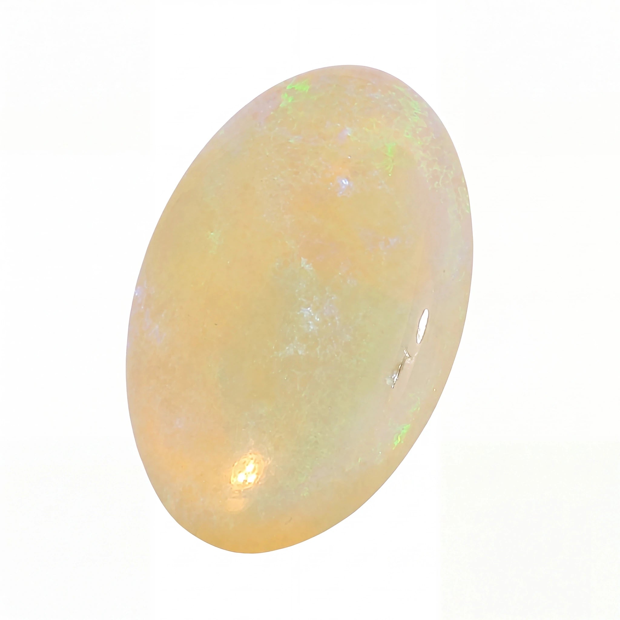 A polished oval cabochon gemstone with a soft peachy-orange body and subtle iridescent flashes of green and blue, set against a plain white background.
