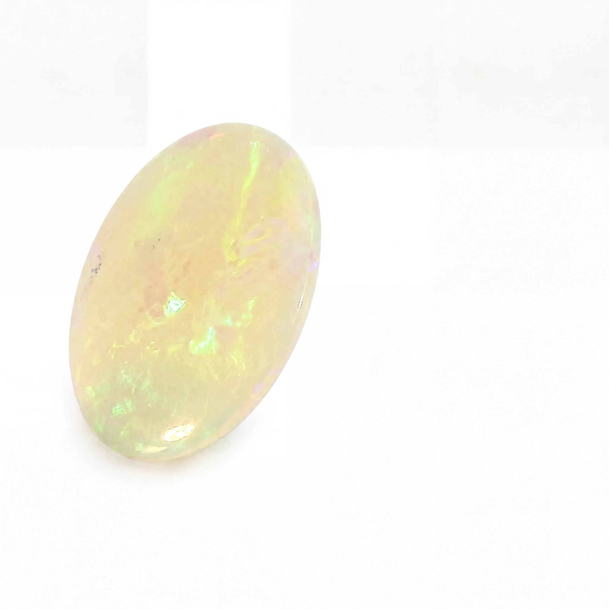 Oval-shaped opal gemstone on a white background