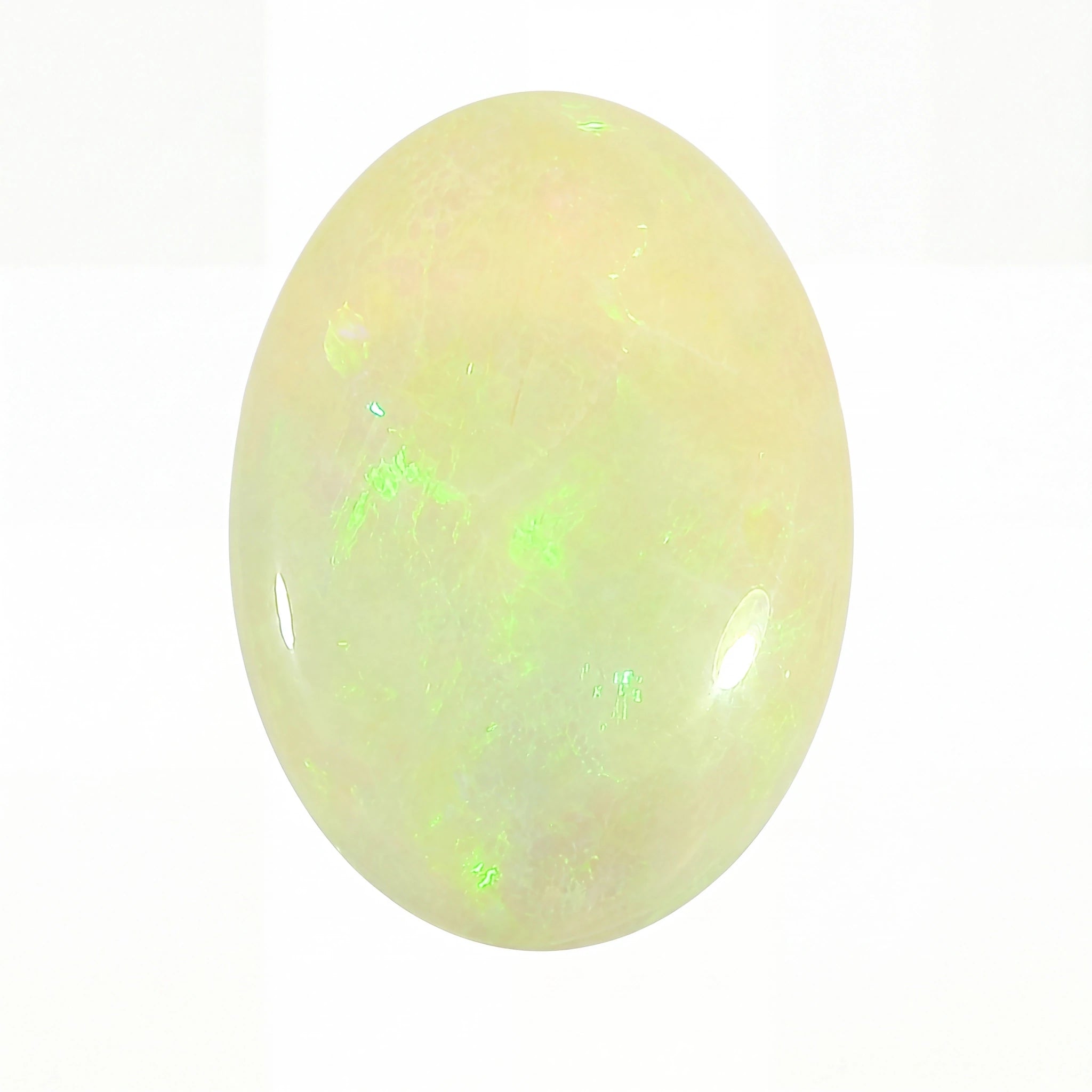 A polished oval cabochon gemstone with a milky white to pale yellow body and vibrant green iridescent flashes, shown on a plain white background.