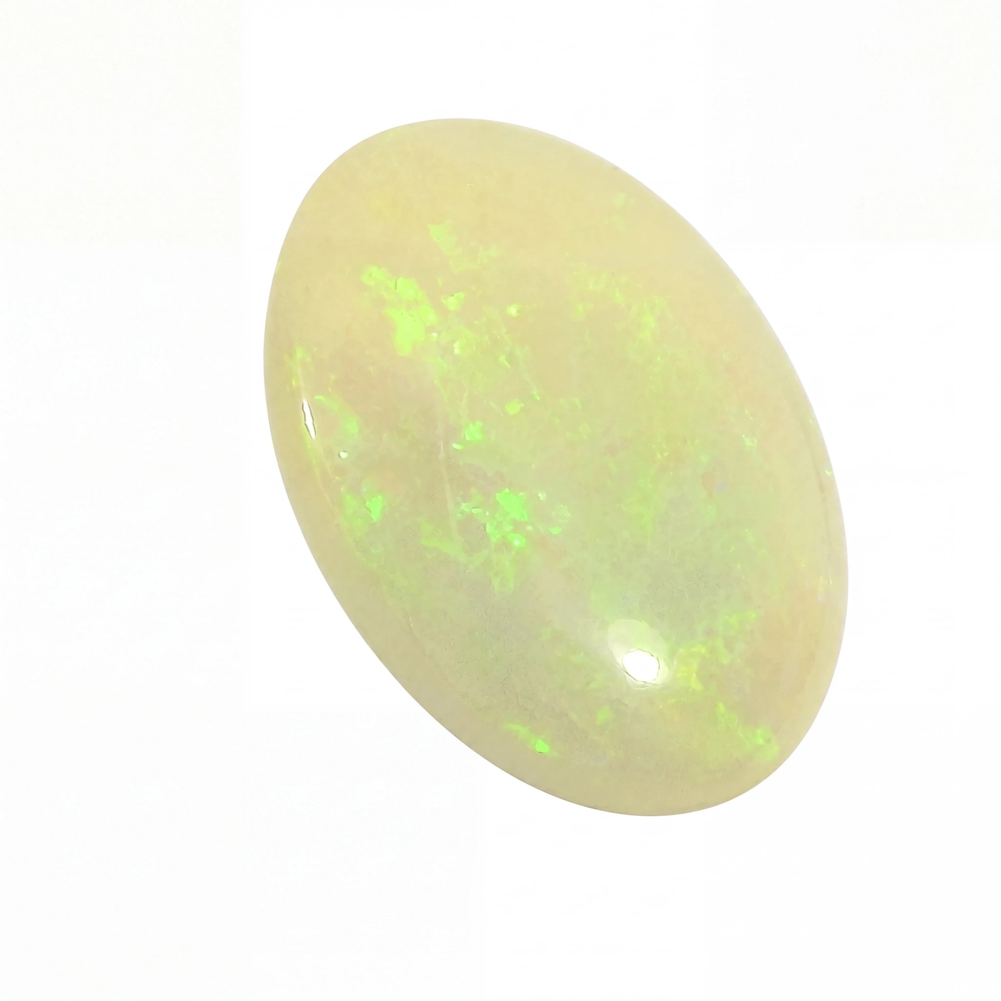 A polished oval cabochon gemstone with a creamy off-white body and vibrant green flashes, shown on a plain white background.