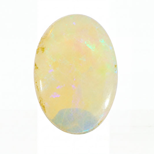 Opal stone with iridescent colours on a white background