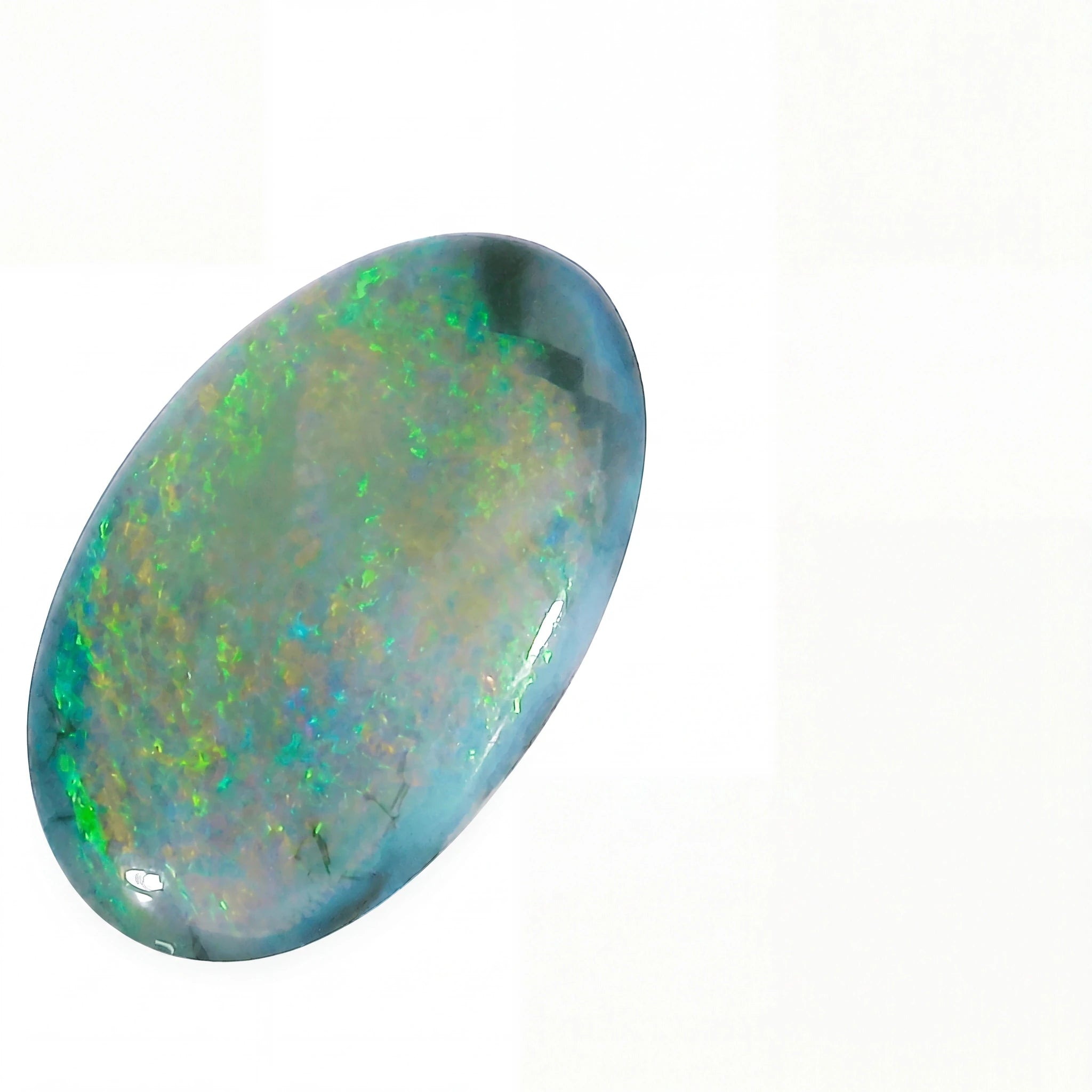 A polished oval cabochon gemstone showing a play-of-colour iridescent surface with blue, green, and white tones on a plain white background.