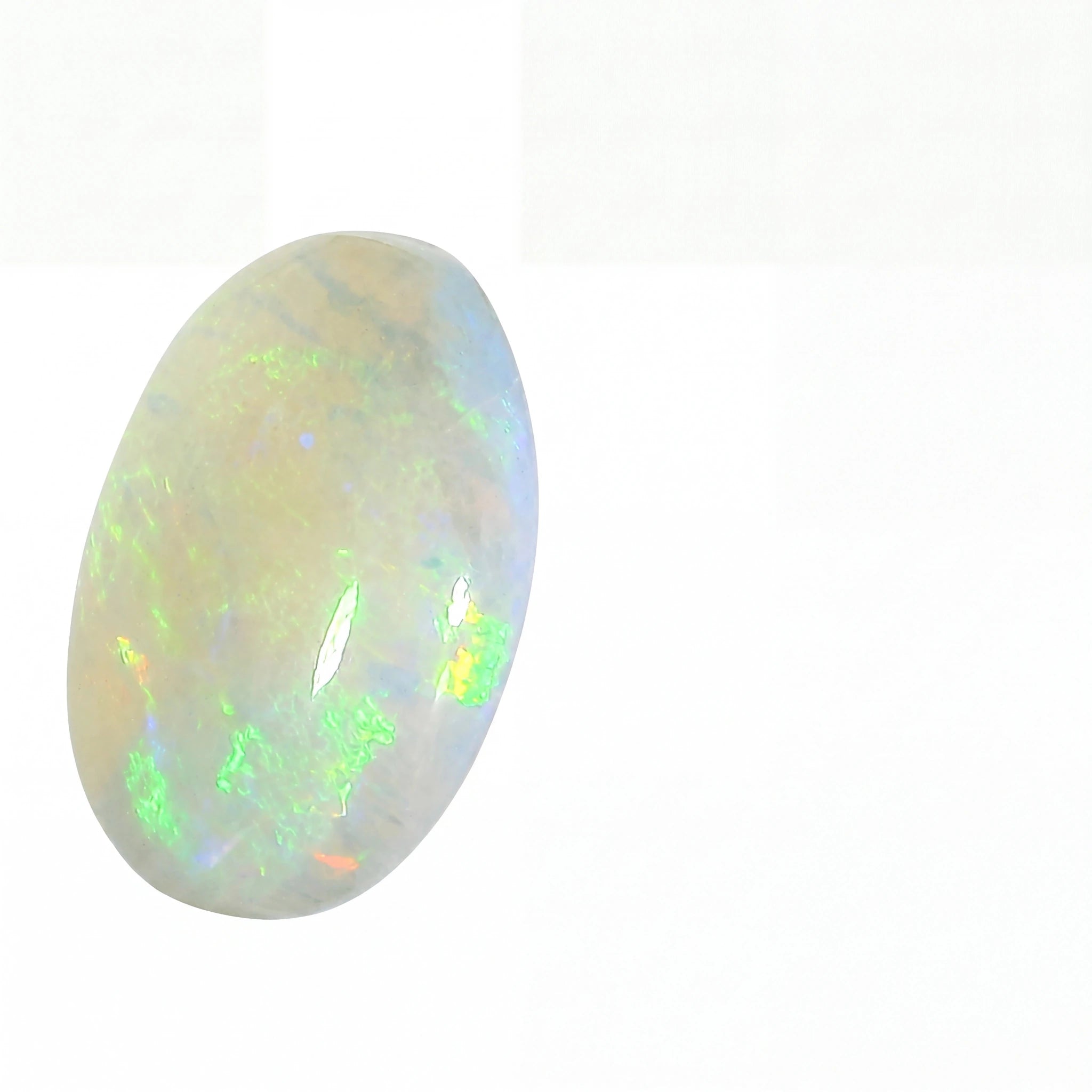 A polished oval cabochon opal gemstone displaying a play-of-colour with green, blue, and orange flashes on a white background.