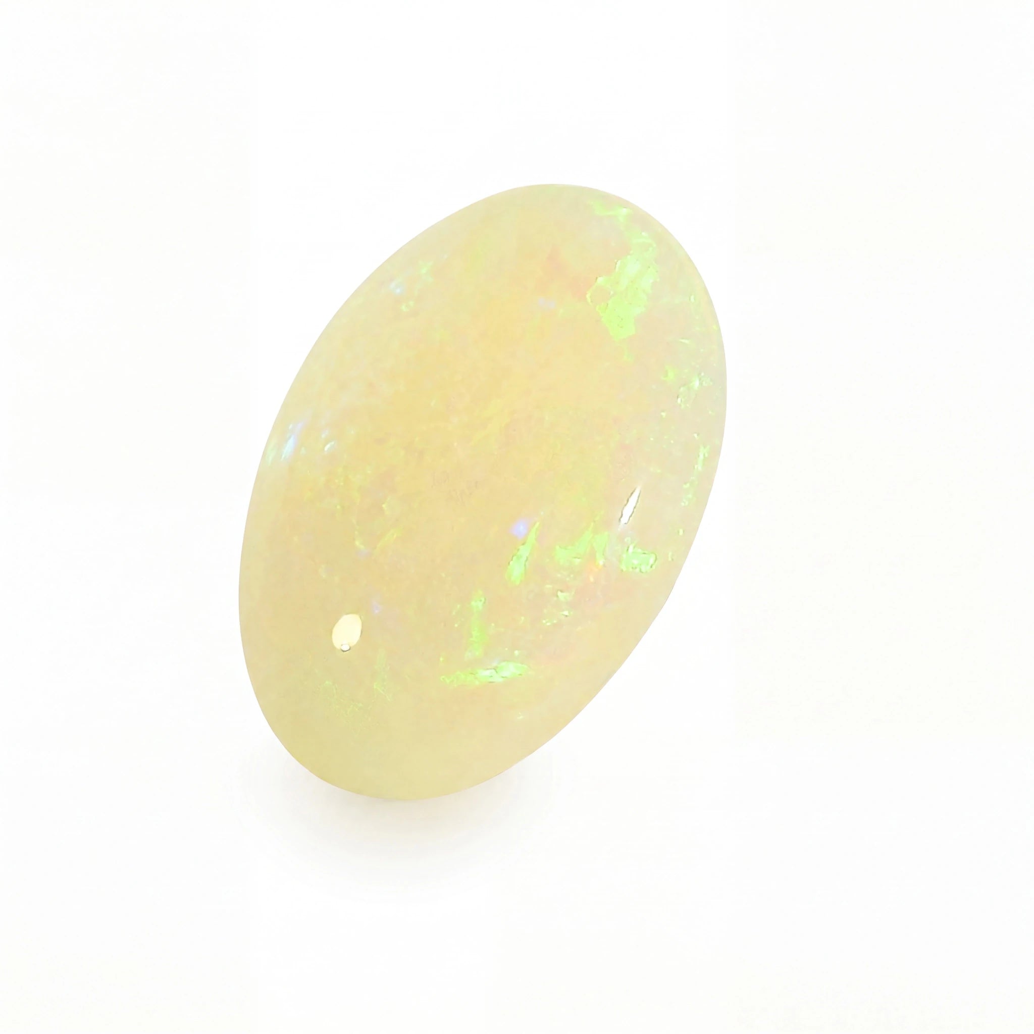 A polished oval cabochon gemstone with a milky white to pale yellow body and vibrant flashes of green and blue iridescence, shown on a plain white background.