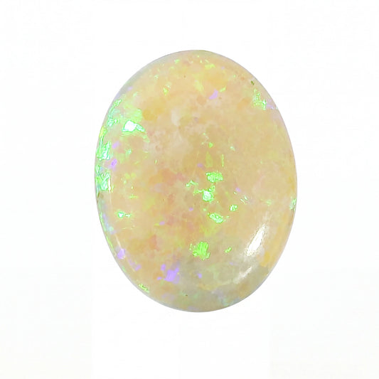 A polished oval cabochon gemstone with a soft peachy-pink base and iridescent flashes of green, blue, and purple, set against a plain white background.