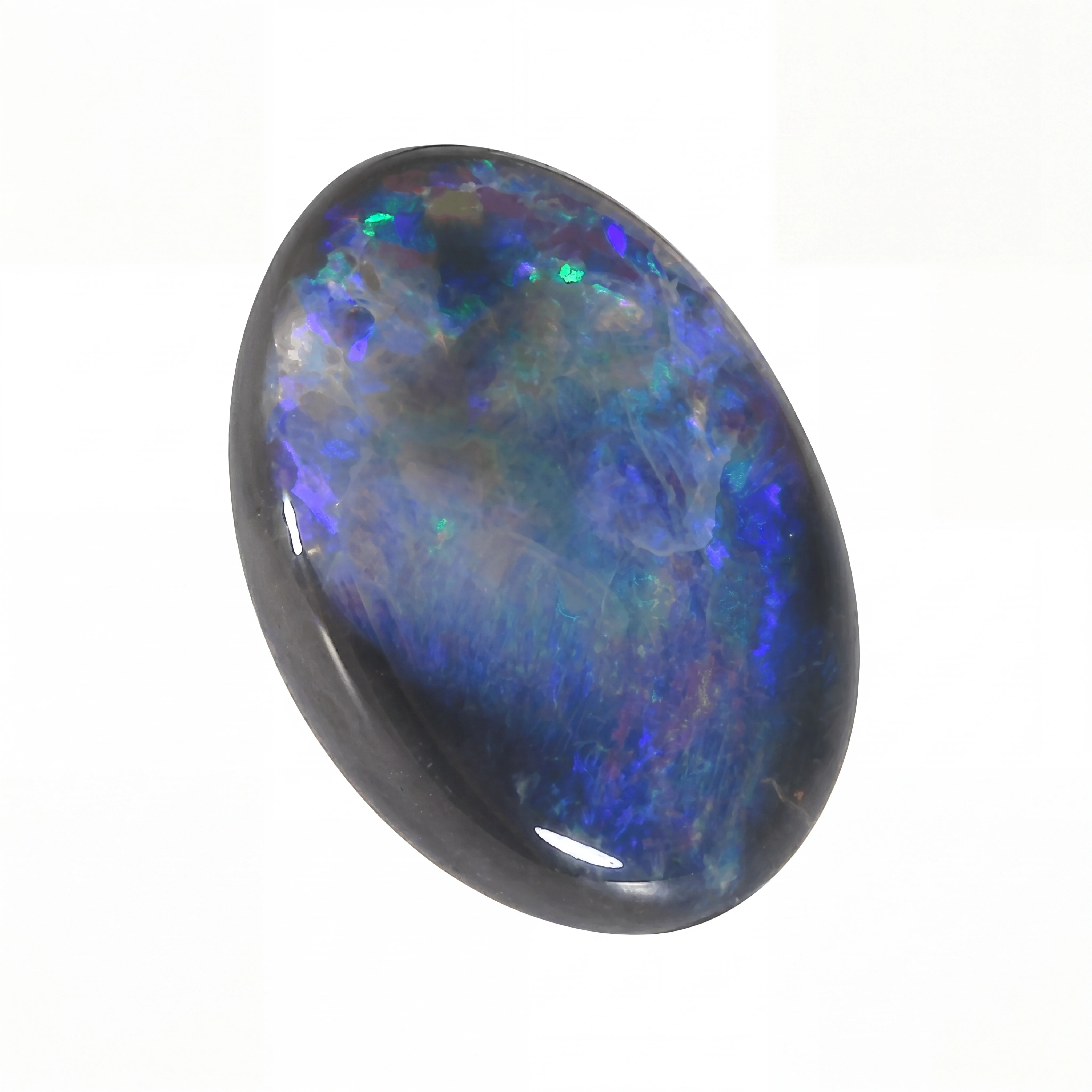 Oval-shaped opal stone with multicoloured play of light on a white background