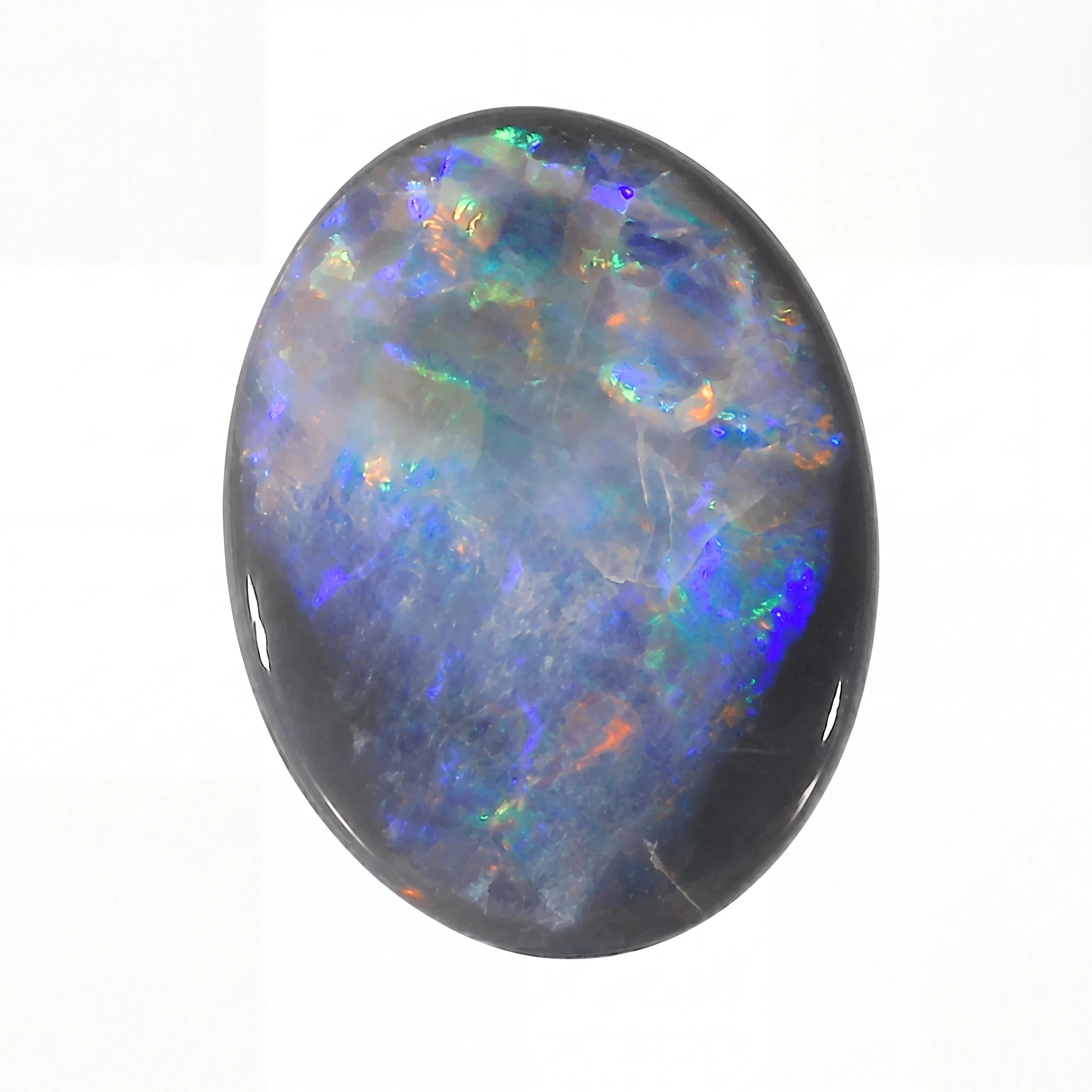 Oval-shaped opal stone with multicoloured play of light on a white background