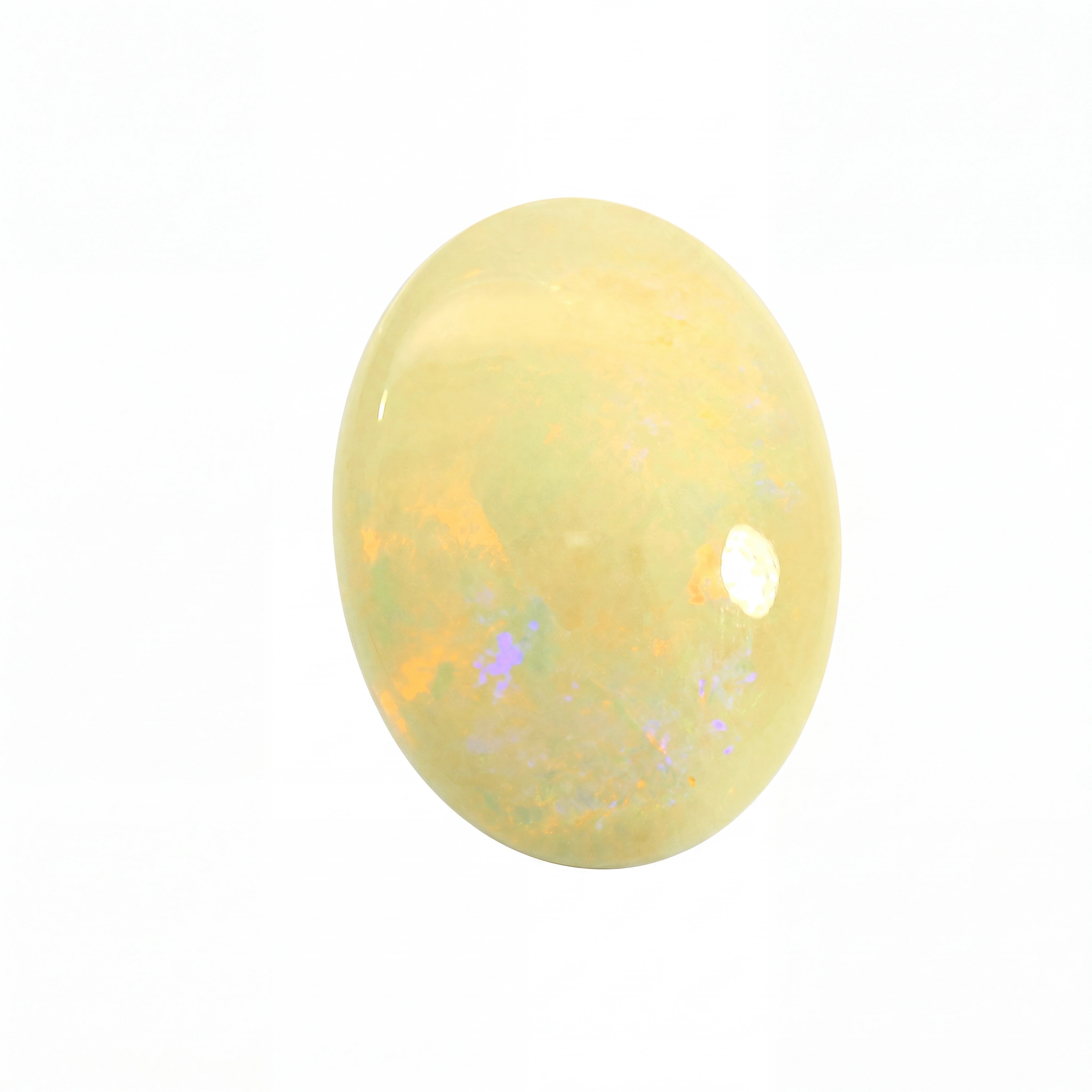 Yellow opal stone with speckled patterns on a white background