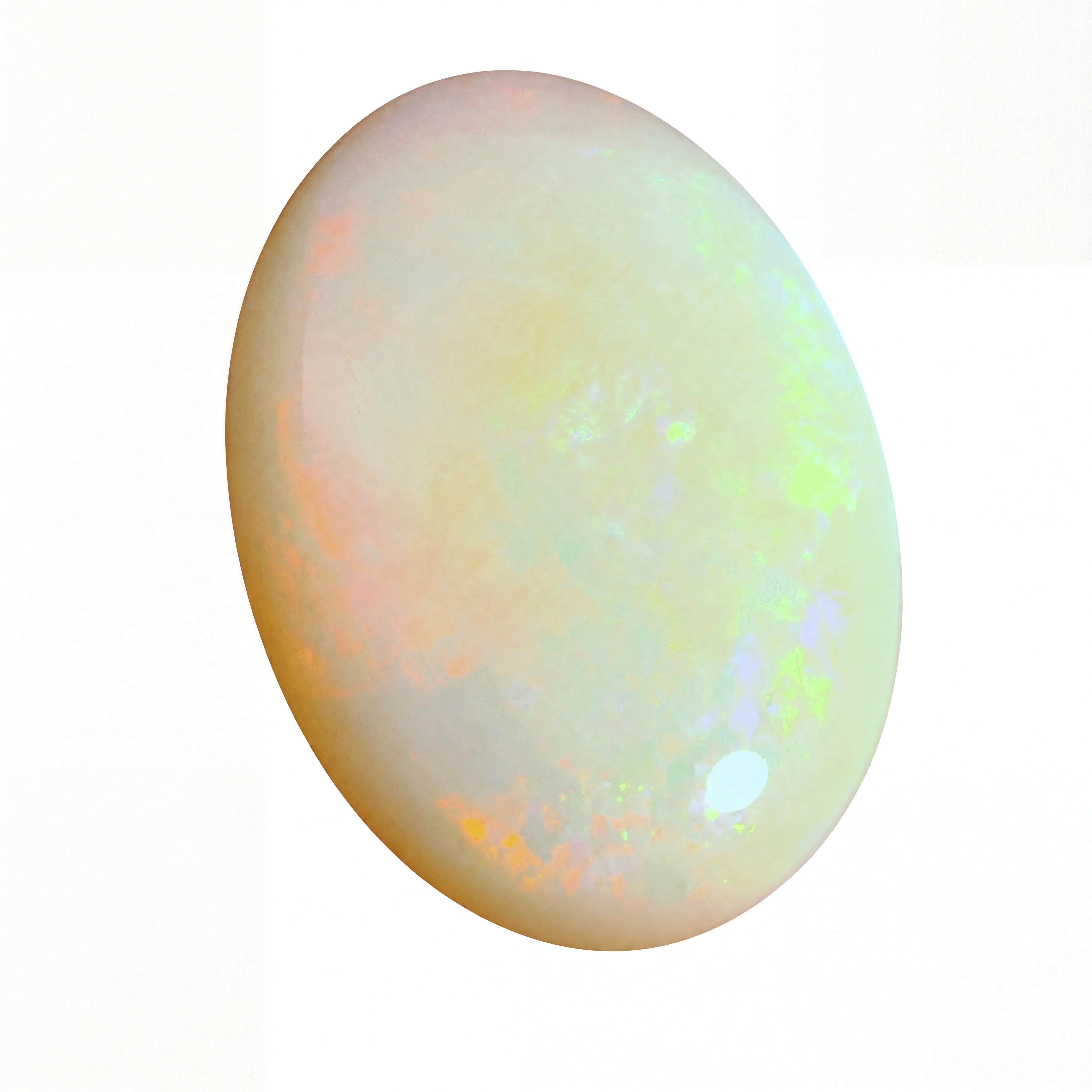 Opal gemstone with multicoloured play of light on a white background