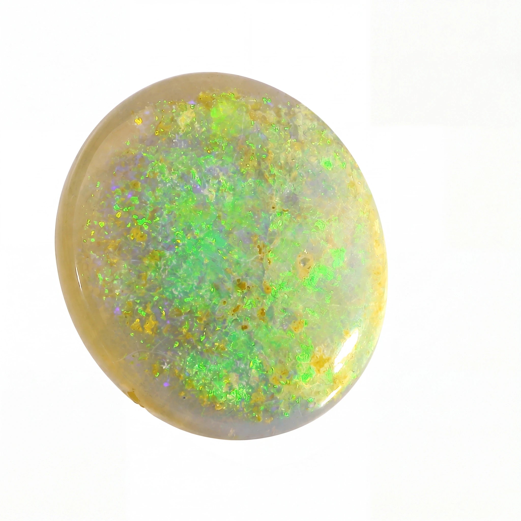 Round opal stone with green and yellow fluorescence on a white background