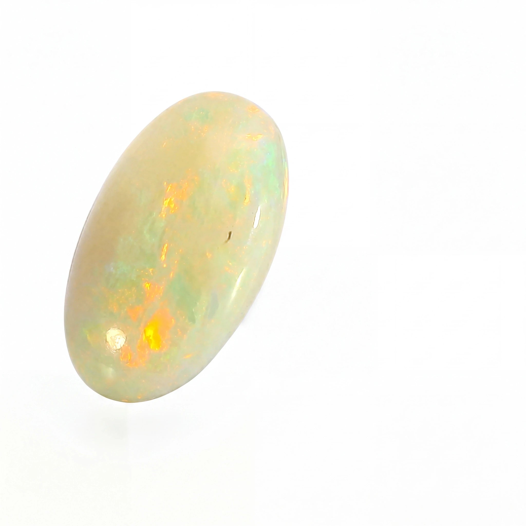 A polished oval cabochon opal gemstone displaying a mix of creamy white, pale green, and vibrant orange flashes, set against a plain white background.