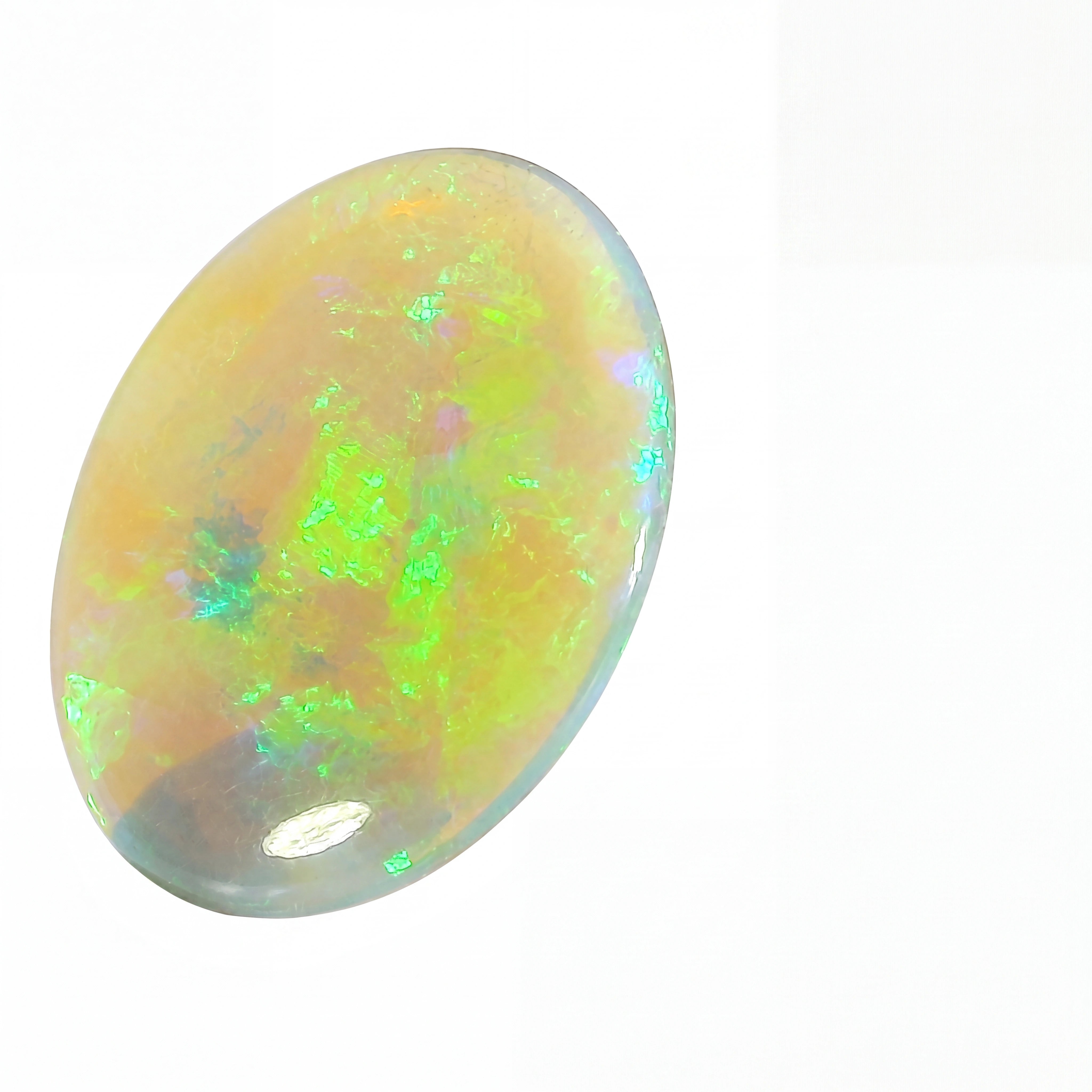 Opal stone with colourful play of light on a white background