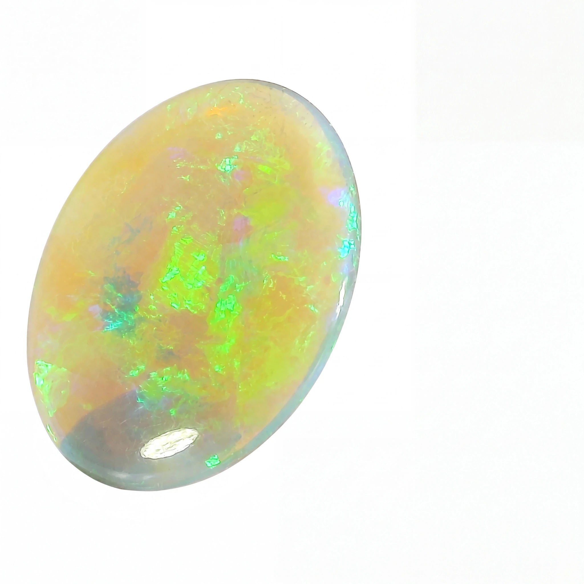 A polished oval cabochon opal gemstone displaying vibrant iridescent flashes of green, blue, and orange on a pale cream base, set against a plain white background.