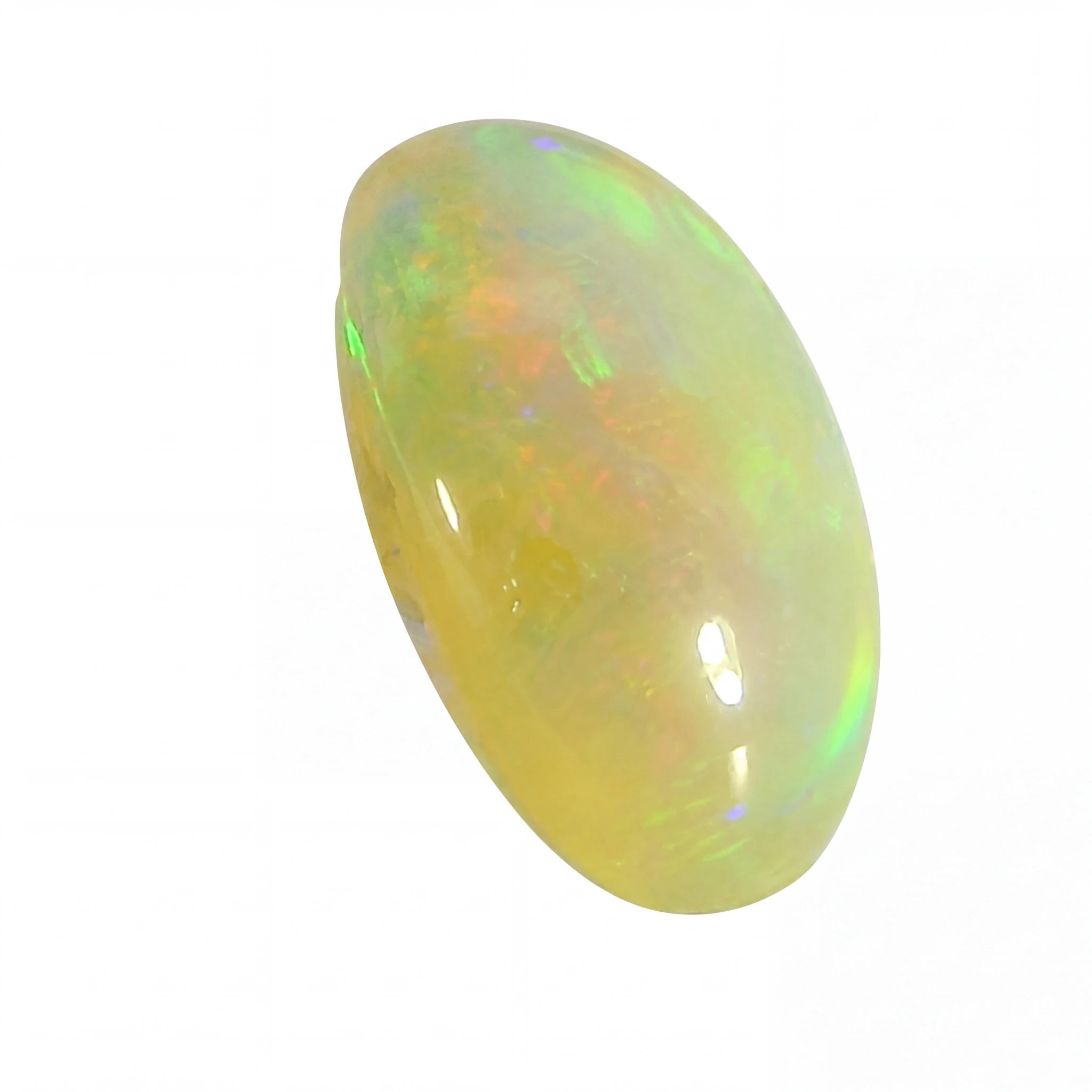 A polished oval cabochon opal gemstone displaying a soft yellow base with iridescent flashes of green, blue, and orange, set against a plain white background.