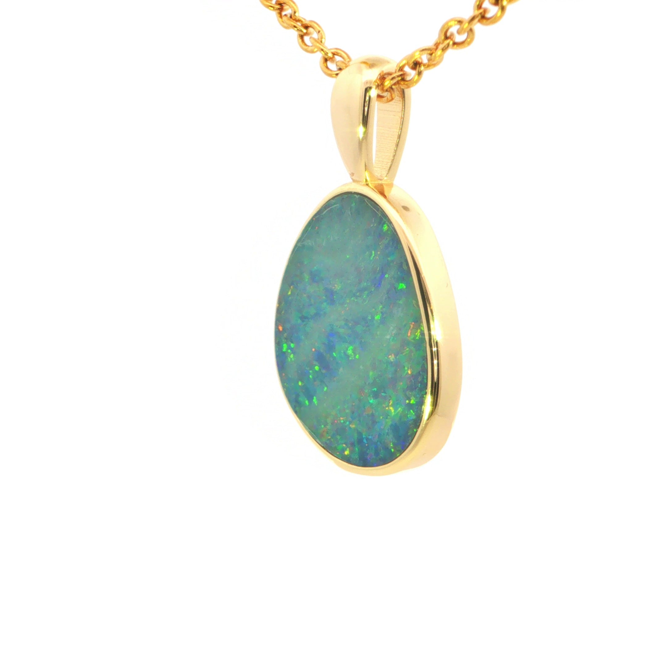 Opal pendant necklace with gold chain on a white background