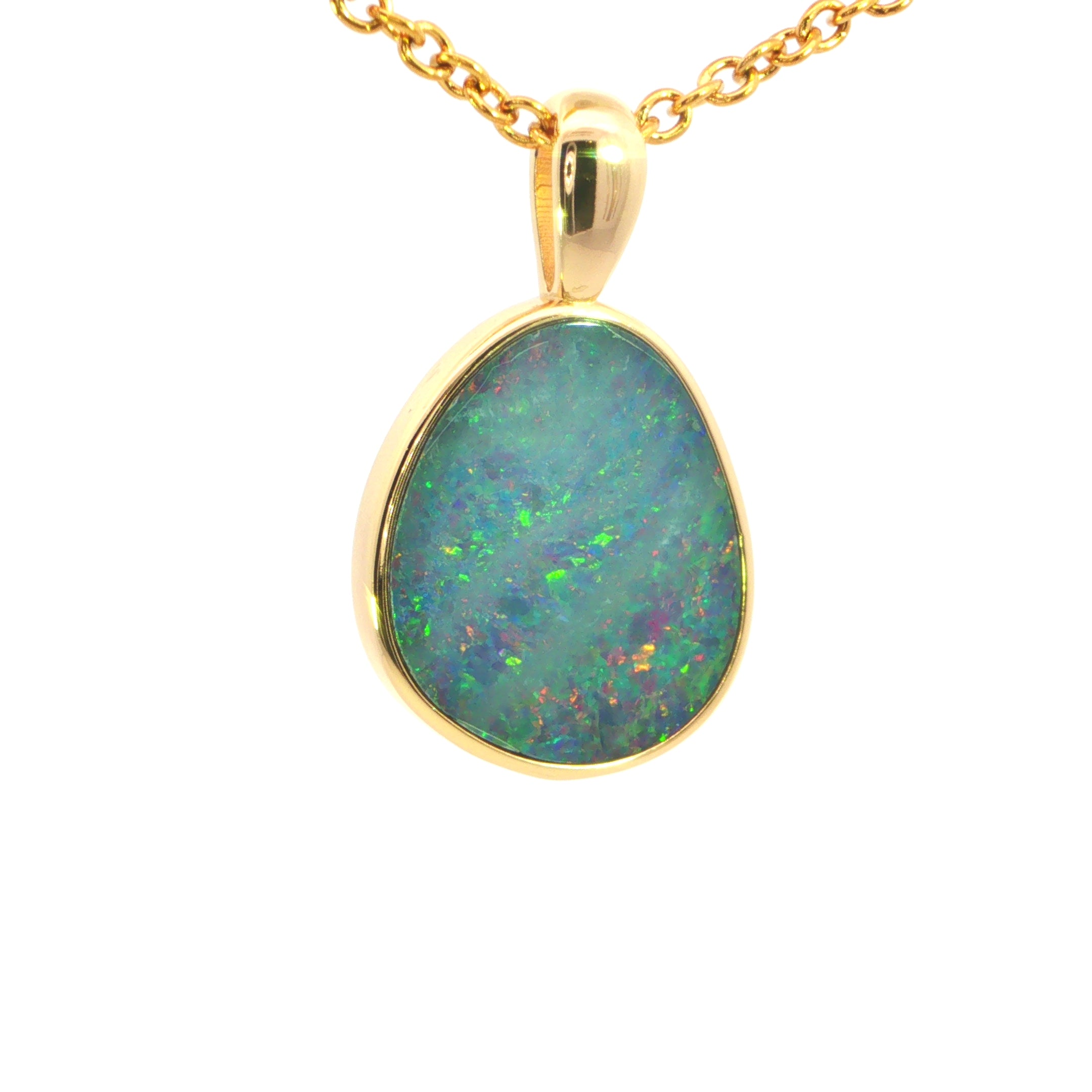Opal pendant on a gold chain against a white background