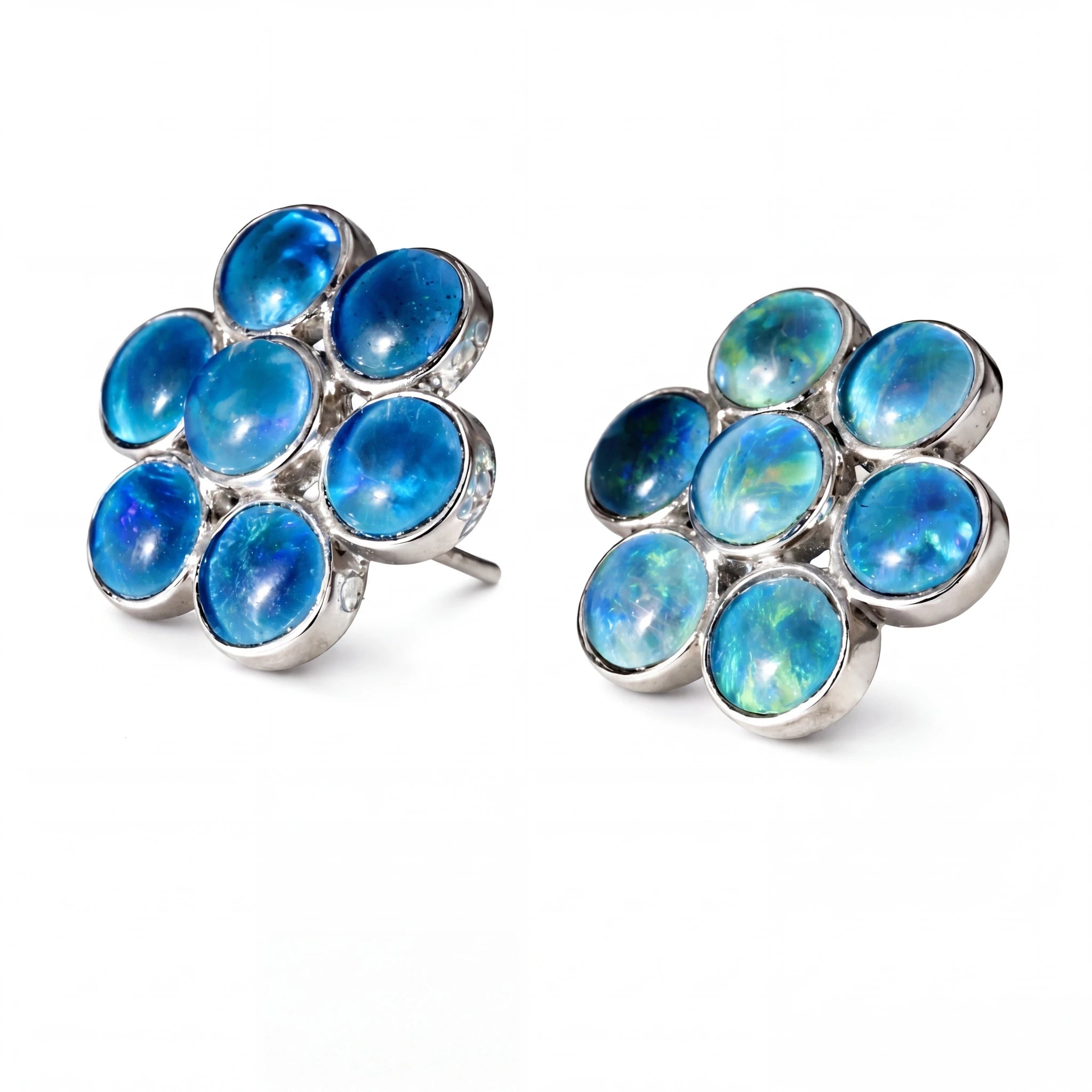 Pair of silver earrings with blue gemstones on a white background