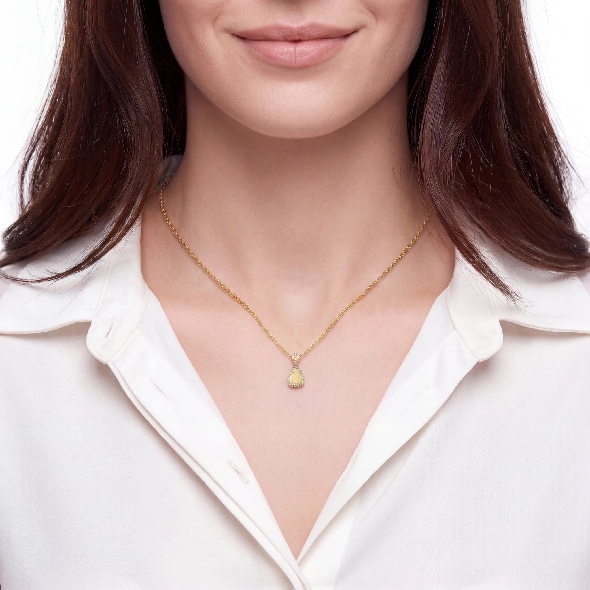 Woman wearing a gold necklace with a heart pendant on a white background