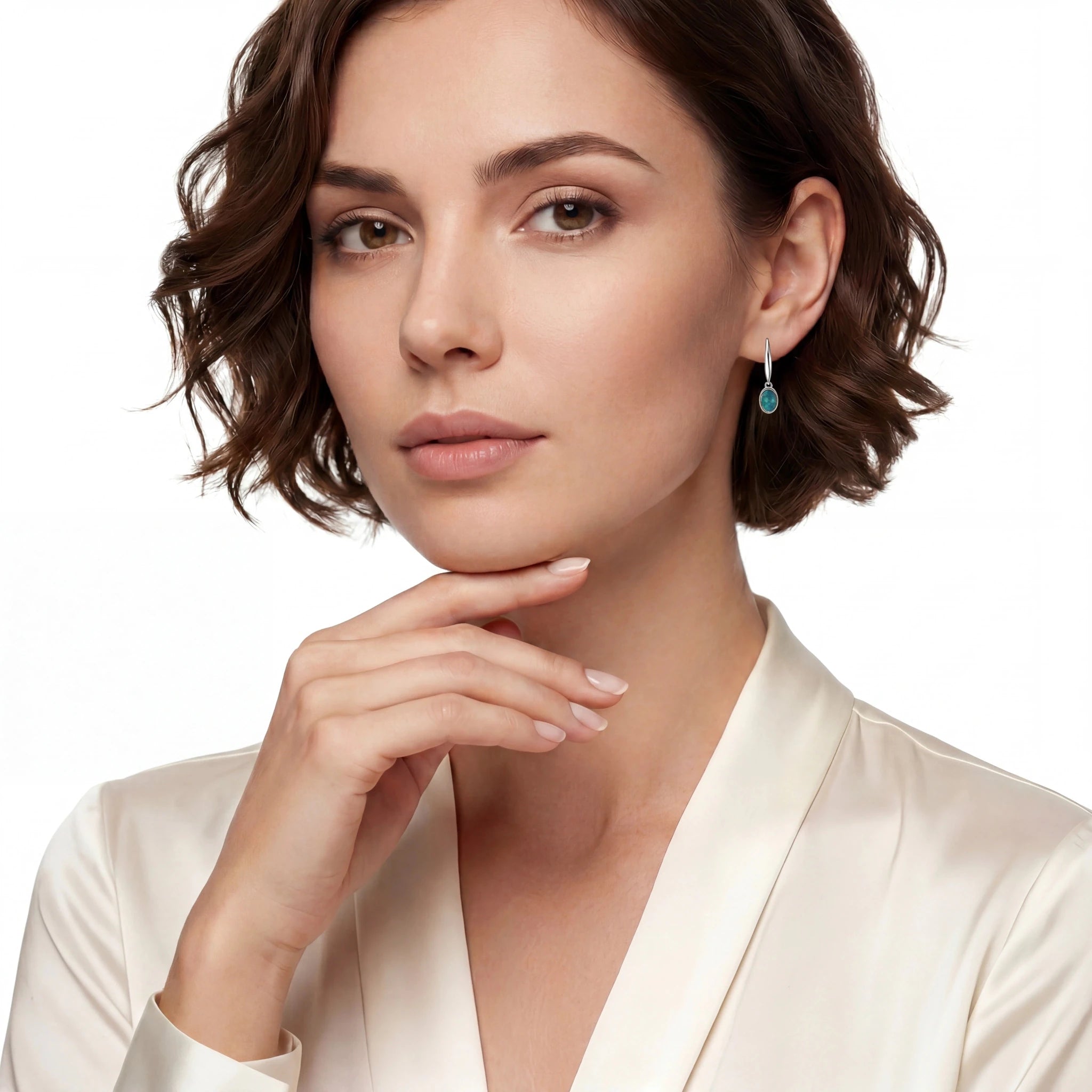 Woman wearing a white satin robe and opal earrings