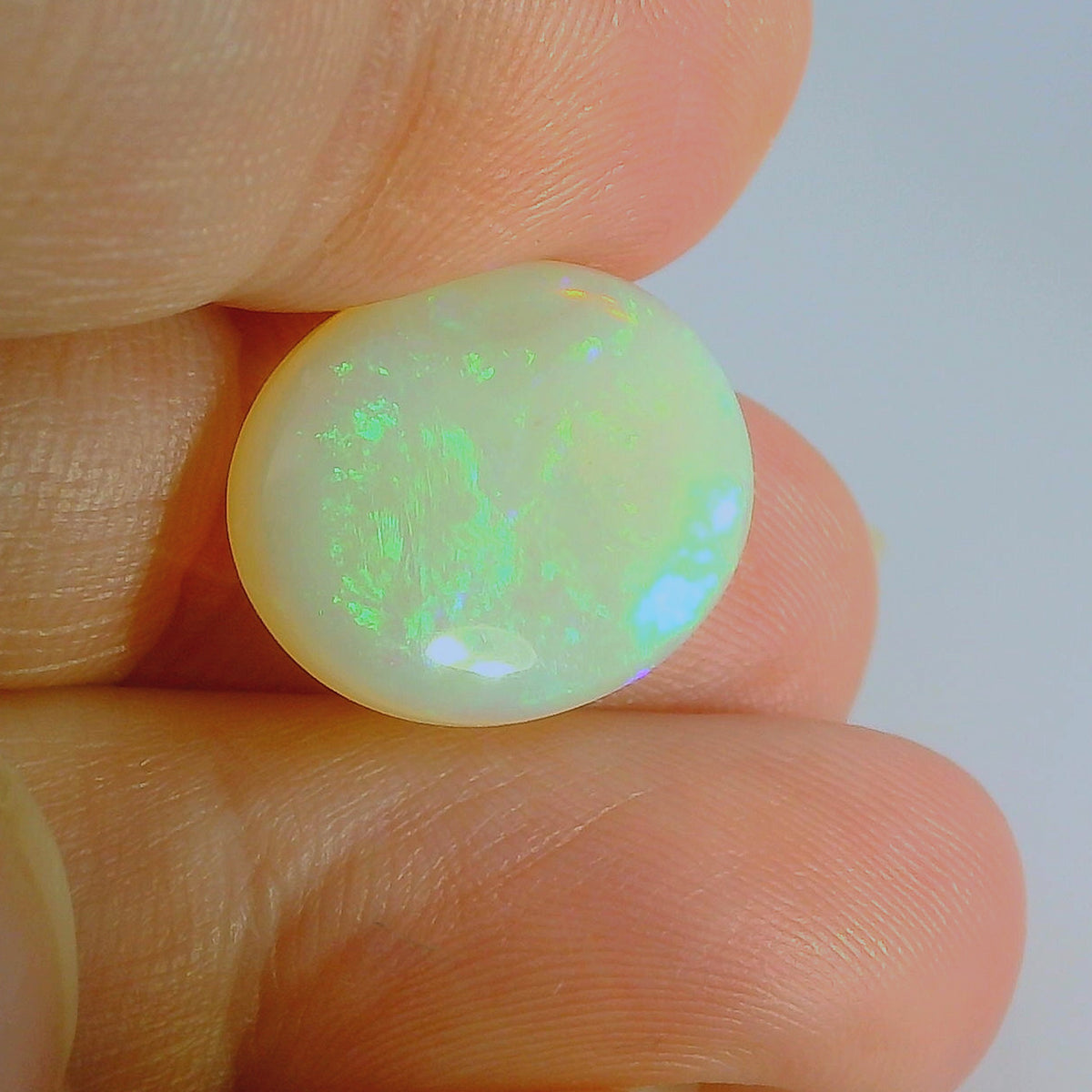 Glistening Opal Gemstone in Hand
