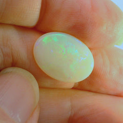 Glistening Opal Gemstone in Hand