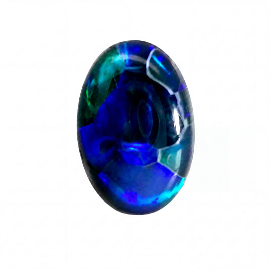 A polished oval cabochon gemstone featuring vibrant blue, teal, and green iridescent play-of-colour on a solid white background.