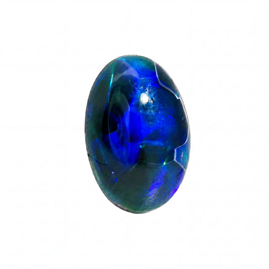 A polished oval cabochon gemstone featuring a vibrant play-of-colour with deep blue, electric green, and hints of purple on a solid white background.