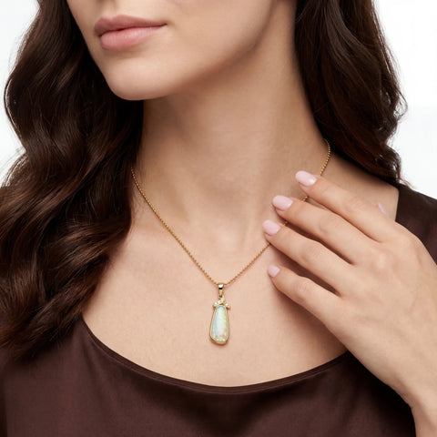 Woman wearing a gold necklace with a pendant