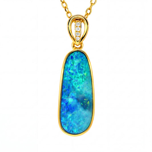 A gold pendant necklace featuring a large, teardrop-shaped blue opal stone with vibrant green and orange flashes, set in a polished gold bezel. The bail of the necklace is gold and features three small clear stones.
