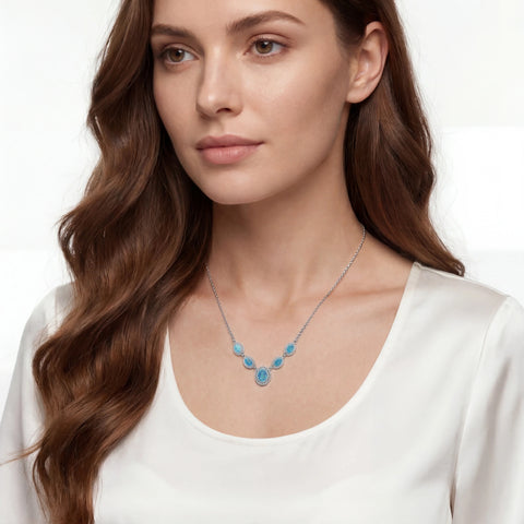 Woman wearing a necklace with blue opal stones on a white background
