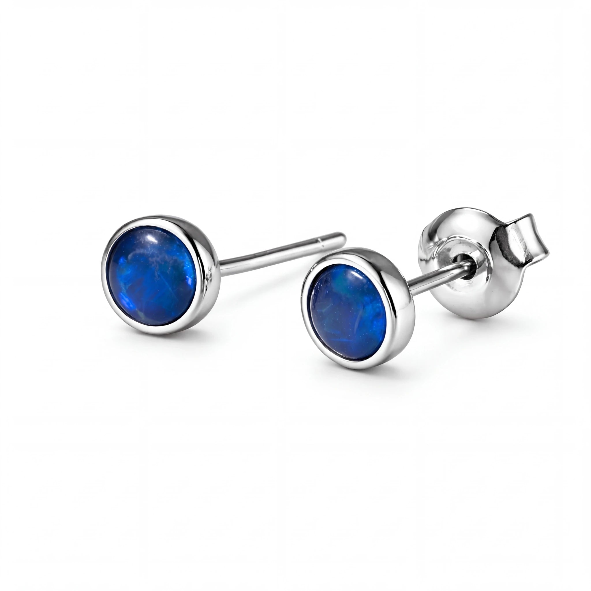 Pair of silver earrings with blue gemstones on a white background