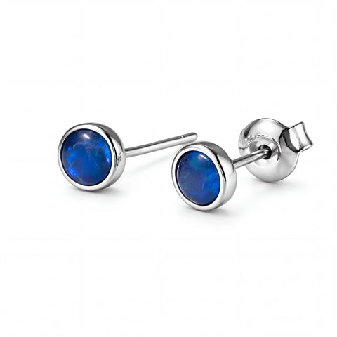 Pair of silver earrings with blue gemstones on a white background