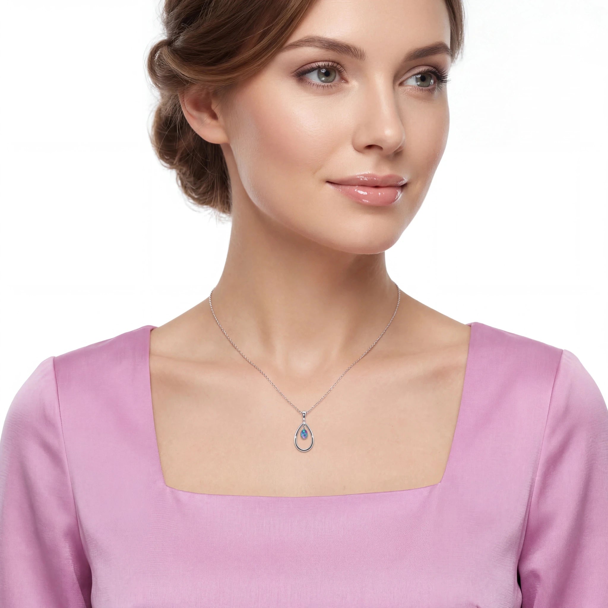 Woman wearing a necklace with a pendant on a white background