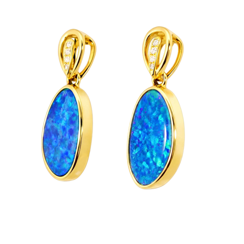 Pair of gold earrings with blue opal stones on a white background