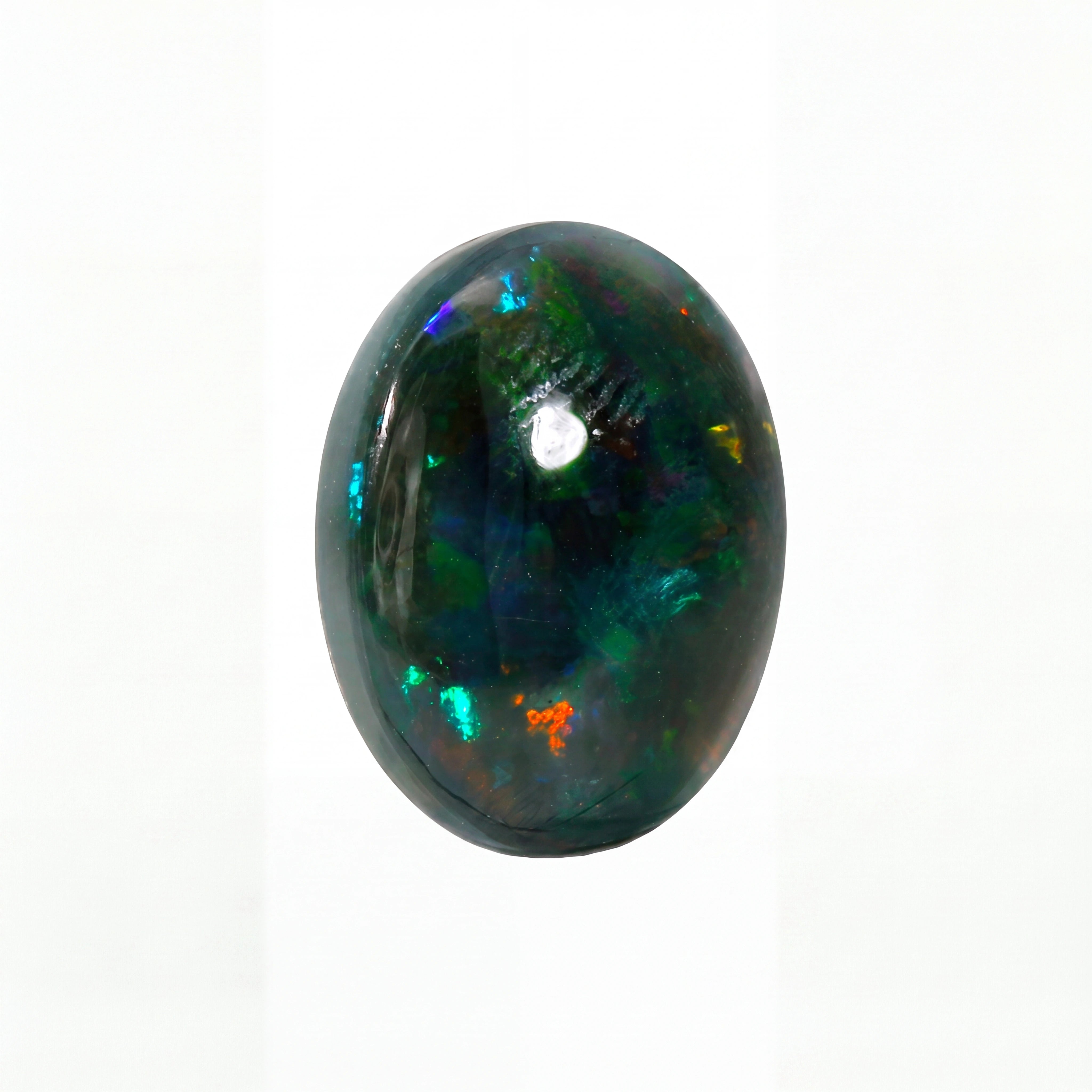 A polished oval cabochon gemstone, likely an opal, displaying a dark black base with vibrant, shifting flashes of green, blue, and orange, set against a plain white background.