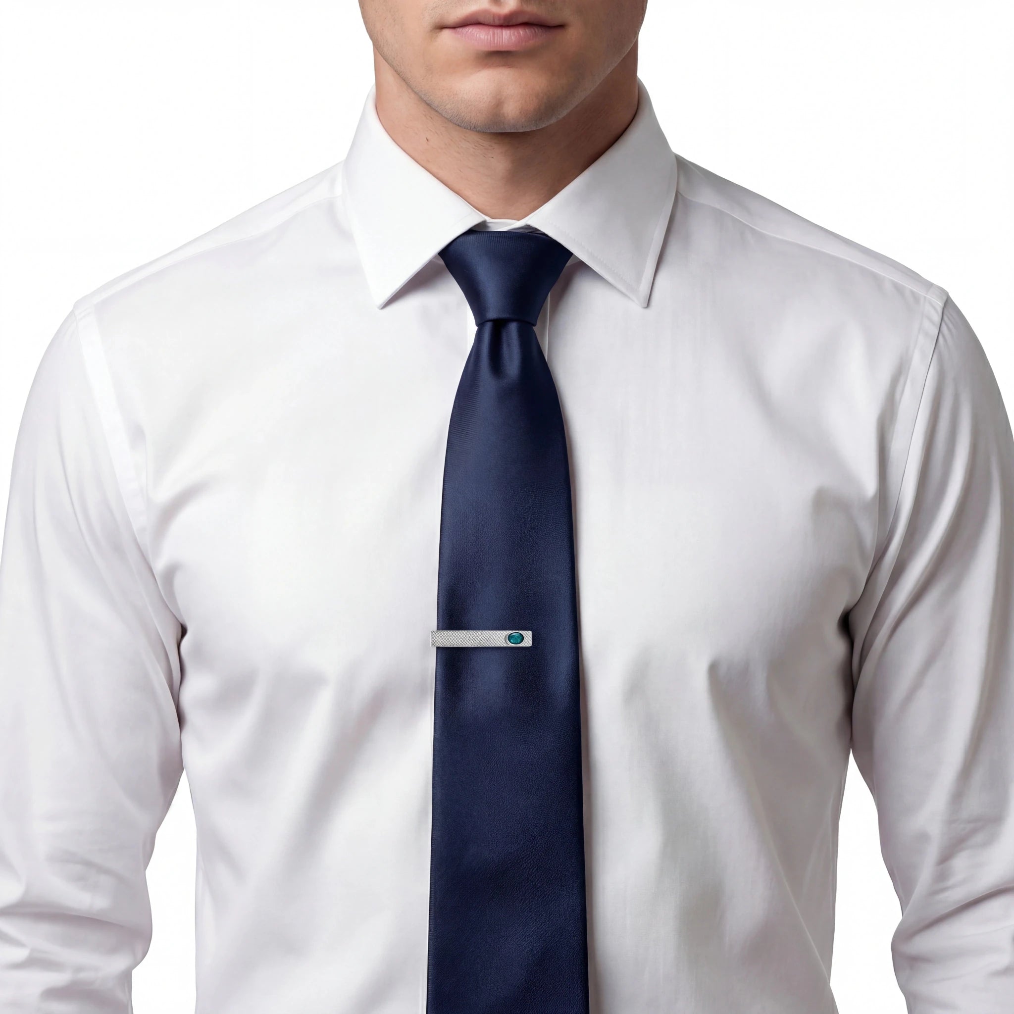 Man wearing a white shirt with a blue tie and a silver tie clip on a white background