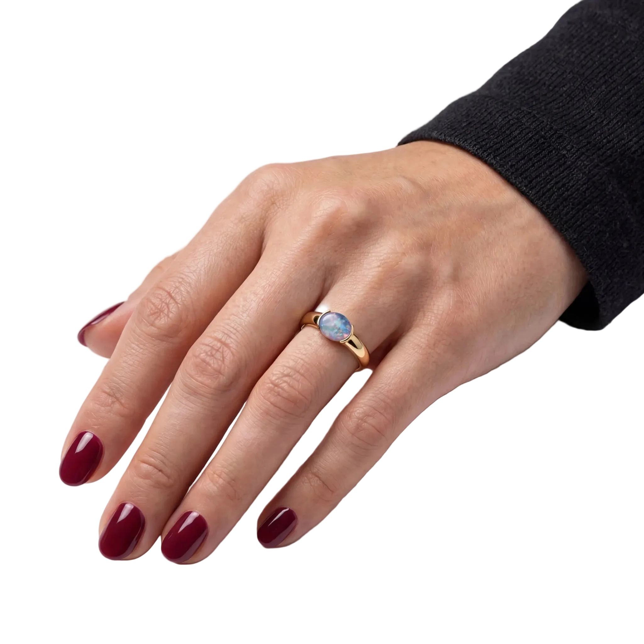 Woman wearing a gold ring with a blue opal gemstone