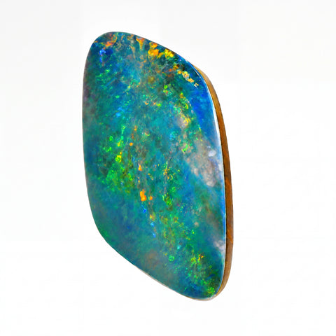 A polished cabochon opal gemstone with vibrant blue, green, and orange play-of-colour, set in a natural brown bezel, shown on a plain white background.