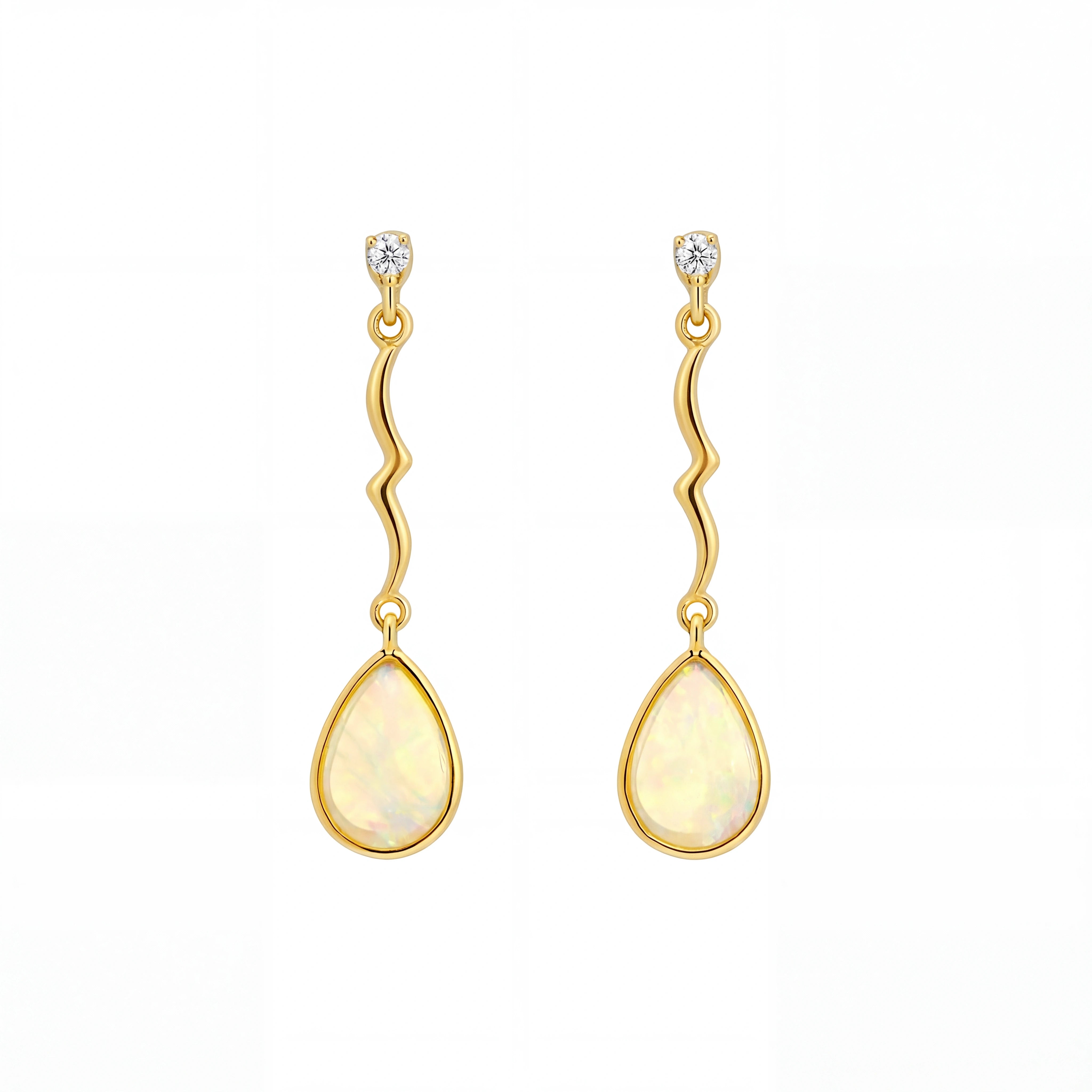 Gold earrings with teardrop-shaped stones on a white background