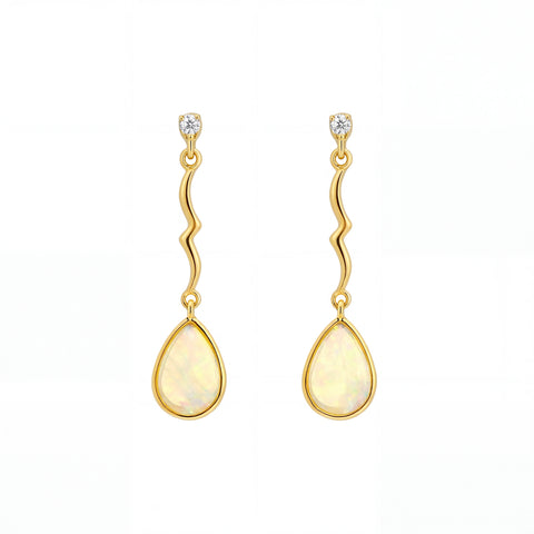 Gold earrings with teardrop-shaped stones on a white background