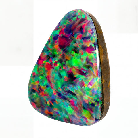 A triangular natural opal gemstone with a vibrant multicolour play-of-colour pattern featuring green, pink, purple, and blue, set in a dark brown bezel on a white background.